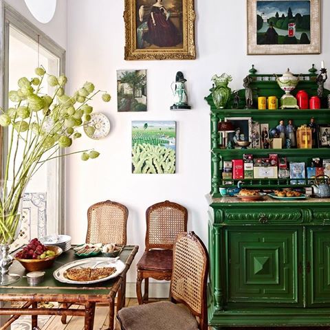 Kitchen’s breakfast area decorated with antique Portuguese chairs, 19th century sideboard and antique English portrait in Interior decorator’s Pedro Espírito Santo’s residence in Lisbon.