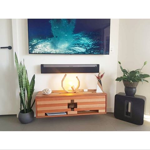 Home. 
This is my entertainment setup. Wall mounted tv and soundbar as well as a  subwoofer(love my music 😉). Floating entertainment unit where everything connects. Decorated with some greenery and a droplet table lamp. #creatingyourvibe #creatingmyvibe #emptylamps www.emptylamps.com
.
.
.
.
.
#emptyfurniture #entertainmentunit #tasoak #contrast #customdesigns #builtforpurpose #tablelamp #thedroplet #theaztec #floatingunit #timberdesign #brisbanedesign #inkapartments #brisbane #westend #4101 #homedecor #interiors #design #unitliving #bne #decor #style #apartment #breezeway #goodgaps #cableaccess