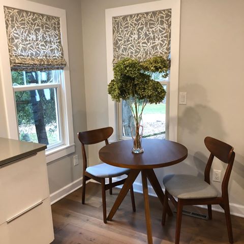 Tried to make the most out of an adorable but petite breakfast nook! Tables and chairs from @westelm, blinds from @blindsdotcom (print is Viburnum Cloudy)
.
@behrpaint color is Silver Drop and barely-in-view cabinets are from @ikeausa
.
#homedecor #homedesign #lakehouse #lakelife #beforeandafter #kitchendesign #breakfastnook #midcenturymodern #romanshades