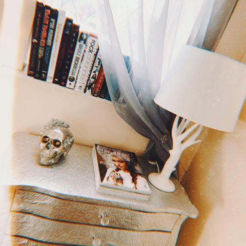 ıllıllı ᗷᗝᗝᛕ ᑕᗝᖇᑎᗴᖇ ıllıllı This small corner at the top of the stairs has some of my favourite things 🖤🖤🖤The lampshade lights up with tress when it’s on.. so cool.. #home #homedecor #homesweethome #bohodecor #boho #books #magazines #lamp #tablelamp #skulls