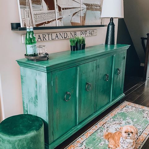 You guys have the best memories!  I have had at least a half a dozen of you ask if we ended up purchasing the green side bar I shared in stories a few weeks ago and the answer is YES!
Here she is in all her glory...still not styled perfectly, I’m on the lookout for a long rectangular tray so if anyone sees one on their journey let me know, thrifted would be great!! And that’s my kitchen runner from @wayfaircanada,  a perfect match or what?
Hubby hung two more @ikeacanada picture ledges for me, one large one small, butted together (like we did in the living room) so I could display one of my most prized possessions, the 3 piece canvas of the Longest Covered Bridge in the World!  This beautiful landmark is in my hometown, where I was born and raised, in Hartland, New Brunswick 🇨🇦. How many of you have seen her?  Or better yet drove or walked through her?  It’s one of the first things we always do when we go Home for a visit.
And to answer your other burning decor questions....we had planned to use three pieces of furniture we brought with us from our last home but they were not a good fit.  So in my usual thrifty fashion, I sold them so we could buy something different!  The side bar is from @bennettsfurniture, the cute stool was on clearance from @walmartcanada, the runner is from @wayfaircanada and the picture ledges are of course @ikeacanada.  We’ve continued the same paint colour “Off White” by @behrpaint out into this hallway.
I’m loving green so much and I totally see it as a neutral in #mymonochromehome 💚
#sidebar #greenaccents #greenisthenewblack #modernrustic #thriftyshopper #homedecor #mystoryfilledhome #decorcircle #mymodernlook #makingmyhaven #storymesocial #behrmarquee #bhghome #wayfaircanada #wayfairathome #interior123 #interiordesign #showoffyourdecorstyle #howwedwell #diyer #diyblogger #myhomevibe #homestyling #letmeinspireyou #saynotoemptywalls #theblushhomepresets #doingneutralright