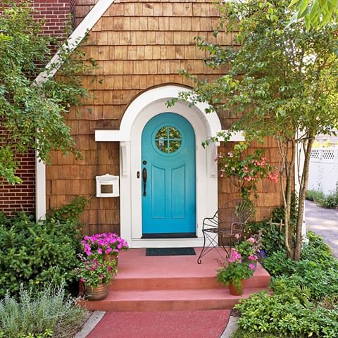 A cheery blue door + bright containers = love at first sight 🌿💕The white casting and neutral siding really make the turquoise door pop! Tip: when choosing a hue for your front door, consider the color of walkways and exterior siding, and select a shade found on the opposite side of the color wheel for contrast. Inspired to repaint your front door this spring? Show us the finished look by tagging your photos with #bhghome. Link in bio for more ways to create high-end curb appeal for less. 📷: @janetmesicmackie | Homeowners: Maureen and Dick Hammond | Producer: Hilary Rose | Architect: Bud Dietrich